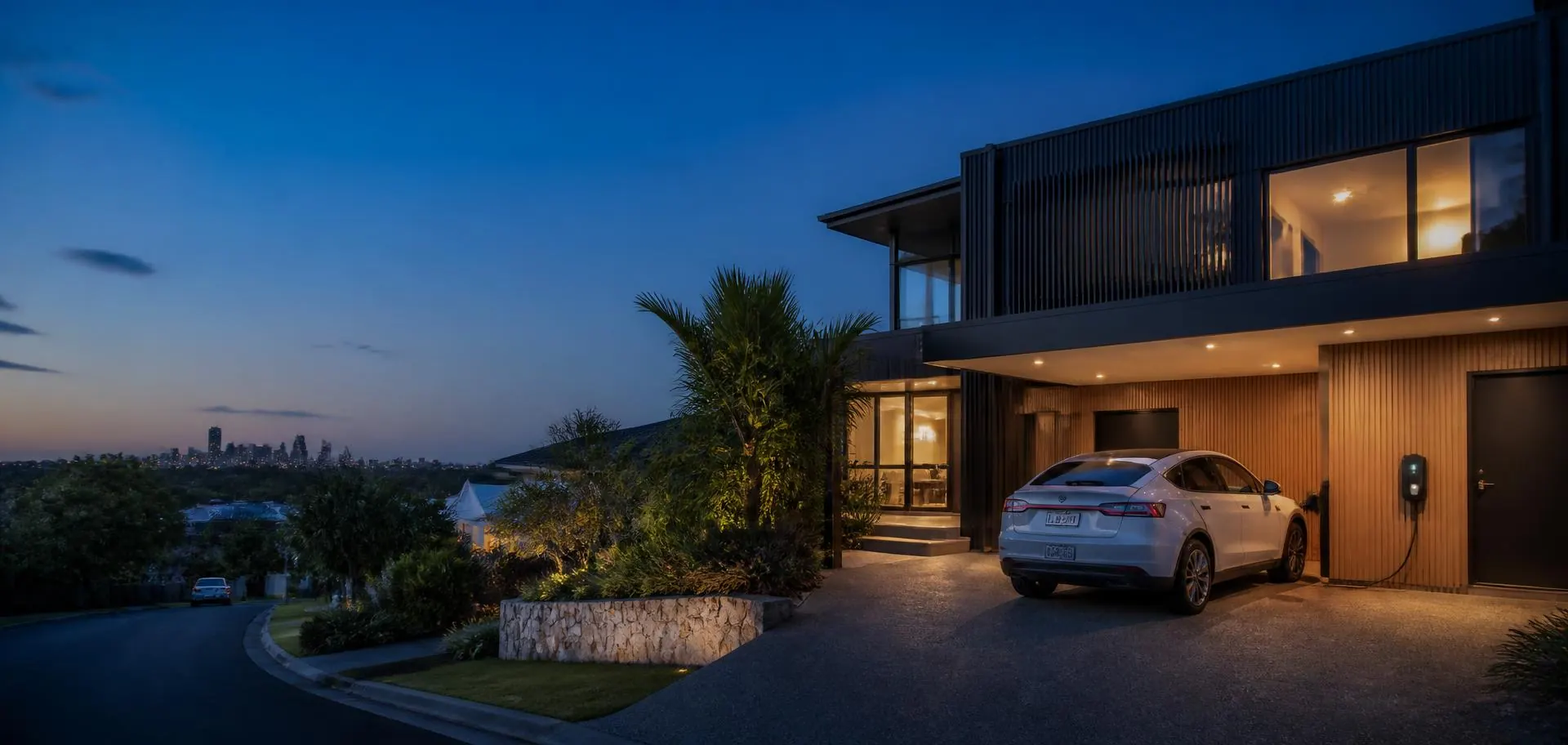 Contemporary Perth home at dusk with an electric car charging in the driveway