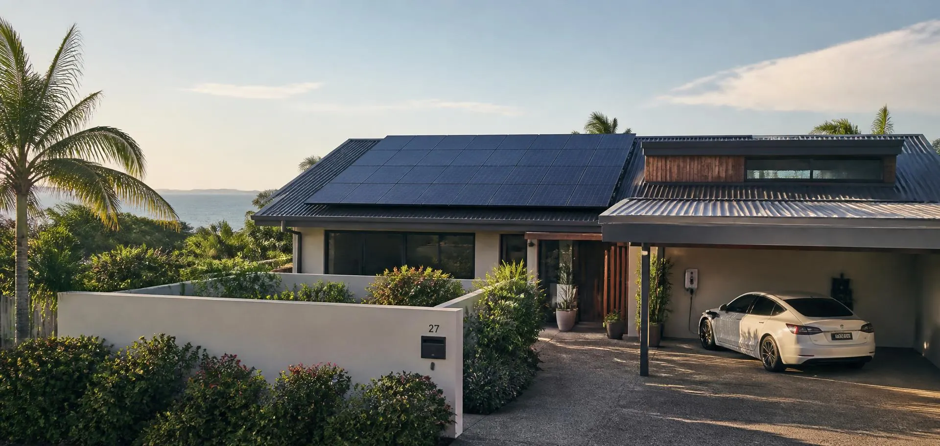 Western Australia home with rooftop solar panels and an electric car charging in the carport in afternoon light
